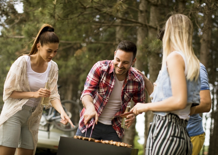 young-people-enjoying-barbecue-party-nature