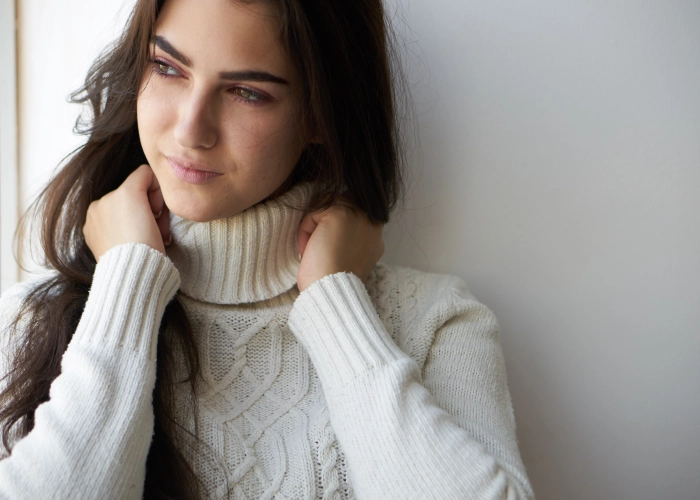 portrait-young-woman-standing-against-wall